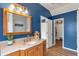 Bathroom featuring double vanity with wood cabinets and a separate walk-in closet at 4037 Hill Station Ct, Sugar Hill, GA 30518