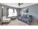 Bedroom with a daybed, a floor lamp, large window with drapes, and neutral carpeting at 4037 Hill Station Ct, Sugar Hill, GA 30518