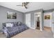 Cozy bedroom featuring neutral carpeting, ceiling fan, and a daybed with decorative pillows at 4037 Hill Station Ct, Sugar Hill, GA 30518