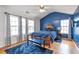 Bright bedroom featuring vaulted ceiling, hardwood floors, and ample natural light at 4037 Hill Station Ct, Sugar Hill, GA 30518
