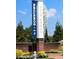 Beautifully landscaped community entrance sign reading 