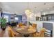 Bright dining area open to the kitchen and living room with stylish chairs and a modern light fixture at 4037 Hill Station Ct, Sugar Hill, GA 30518