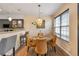 Cozy dining area with stylish chairs, a modern light fixture, and large windows for natural light at 4037 Hill Station Ct, Sugar Hill, GA 30518