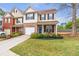 Charming two-story townhome with a well-manicured lawn and inviting curb appeal at 4037 Hill Station Ct, Sugar Hill, GA 30518