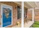 Charming brick home featuring a welcoming blue front door and cozy porch seating at 4037 Hill Station Ct, Sugar Hill, GA 30518