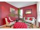 Comfortable living room with vibrant red walls, plush seating, and bright natural light at 4037 Hill Station Ct, Sugar Hill, GA 30518