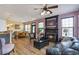 Spacious living room with a fireplace, open to the kitchen and dining area, creating a welcoming atmosphere at 4037 Hill Station Ct, Sugar Hill, GA 30518