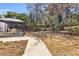The backyard features a gazebo with outdoor furniture, set amidst a backdrop of mature trees and landscaped garden beds at 4090 Cherry Ridge Walk, Suwanee, GA 30024