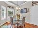 Bright dining area with hardwood floors, natural light, and a decorative chandelier at 4090 Cherry Ridge Walk, Suwanee, GA 30024