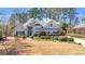 Charming home with lush landscaping, flowering trees, and a well-maintained front yard, creating a welcoming curb appeal at 4090 Cherry Ridge Walk, Suwanee, GA 30024