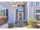 Elegant front entrance showcasing a stone facade, decorative glass door, and manicured landscaping, enhancing curb appeal at 4090 Cherry Ridge Walk, Suwanee, GA 30024
