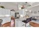 Open floor plan with a kitchen and living area featuring granite countertops, stainless steel appliances and bar seating at 4090 Cherry Ridge Walk, Suwanee, GA 30024