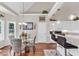 Open floor plan with a combined kitchen and dining area featuring granite countertops, stainless steel appliances, and pendant lighting at 4090 Cherry Ridge Walk, Suwanee, GA 30024