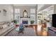 Inviting living room with high ceilings, a cozy fireplace, hardwood floors, and large windows, filled with natural light at 4090 Cherry Ridge Walk, Suwanee, GA 30024