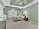 A bright main bedroom features carpet, a ceiling fan, and a large window providing plenty of natural light at 4090 Cherry Ridge Walk, Suwanee, GA 30024