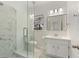 Bright bathroom with white marble tiling, glass enclosed shower, and updated vanity at 517 Toombs St, Palmetto, GA 30268