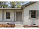 Inviting front entry with a gray painted front door, painted brick, and gray trim at 517 Toombs St, Palmetto, GA 30268