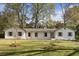 Charming one-story home with painted brick, gray shutters, mature trees, and a well-manicured lawn at 517 Toombs St, Palmetto, GA 30268