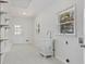 Well-lit laundry room featuring a utility sink and storage shelves at 517 Toombs St, Palmetto, GA 30268