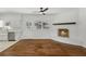 Open living area with hardwood floors, a brick fireplace, and an adjacent kitchen at 517 Toombs St, Palmetto, GA 30268