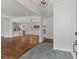 Open-concept living room view of the kitchen and fireplace with hardwood flooring and neutral paint at 517 Toombs St, Palmetto, GA 30268