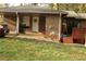 Rear view of brick home with grill, back entrance, and small deck, enhancing outdoor living at 1185 Highway 162, Covington, GA 30016