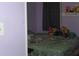 A cozy bedroom with green floral bedding, a rainbow plushie, and muted lilac walls at 1185 Highway 162, Covington, GA 30016