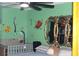 Bedroom with a crib, a bed with a gray blanket, and Lion King wallpaper at 1185 Highway 162, Covington, GA 30016