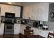 Kitchen featuring stainless steel appliances, white cabinets, and stylish tiled backsplash at 1185 Highway 162, Covington, GA 30016