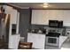 Cozy kitchen with white cabinets and stainless steel appliances and granite countertops at 1185 Highway 162, Covington, GA 30016