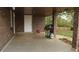 Covered patio with concrete flooring and brick columns, including a grill for outdoor cooking at 1185 Highway 162, Covington, GA 30016