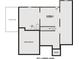 Plan of an unfinished basement with rough-in for a future bathroom, an unexcavated section, and stairs to the upper level at 245 Piedmont Cir, Covington, GA 30016