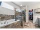 Luxurious bathroom featuring a soaking tub, glass-enclosed shower, and a view of a walk-in closet at 245 Piedmont Cir, Covington, GA 30016
