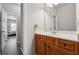 Bathroom featuring a wooden vanity with view into the hallway at 245 Piedmont Cir, Covington, GA 30016