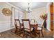 Formal dining room with elegant decor, a stylish chandelier, and a view of the well-lit window at 245 Piedmont Cir, Covington, GA 30016