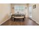 Cozy dining room features wood floors, a modern table with bench seating, and natural light from the window at 245 Piedmont Cir, Covington, GA 30016