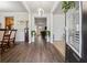 Inviting foyer with hardwood floors, leading to various living spaces, enhanced by a modern light fixture at 245 Piedmont Cir, Covington, GA 30016