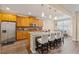 Spacious kitchen featuring granite countertops, a center island with seating, and stainless steel appliances at 245 Piedmont Cir, Covington, GA 30016