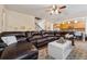 Open-concept living room seamlessly connects to the kitchen with a large sectional sofa and bright natural light at 245 Piedmont Cir, Covington, GA 30016