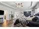Stylish main bedroom with tray ceiling, mirrored dresser, a king-size bed and relaxing gray paint scheme at 245 Piedmont Cir, Covington, GA 30016