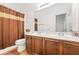 Bathroom features a double sink vanity and a shower with a stylish curtain at 3897 Lake Sanctuary Way, Atlanta, GA 30349