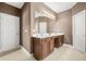 Bathroom featuring double vanity with a large mirror with great lighting and floors at 3897 Lake Sanctuary Way, Atlanta, GA 30349