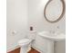 Half bathroom featuring sleek sink and toilet at 3897 Lake Sanctuary Way, Atlanta, GA 30349