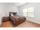 Bright bedroom features a large window, sleek hardwood floors, and modern furniture at 3897 Lake Sanctuary Way, Atlanta, GA 30349