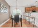 Contemporary dining area featuring modern lighting and barstool seating in the background at 3897 Lake Sanctuary Way, Atlanta, GA 30349