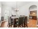 Dining table and chairs beside french doors, located near an open-concept kitchen at 3897 Lake Sanctuary Way, Atlanta, GA 30349