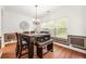 Traditional dining room showcases chair rail molding, wood floors and a chandelier at 3897 Lake Sanctuary Way, Atlanta, GA 30349