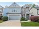 Charming two-story home with a two-car garage, stone accents, and beautiful landscaping at 3897 Lake Sanctuary Way, Atlanta, GA 30349