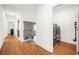 Bright hallway featuring beautiful hardwood floors, and staircase leading to a second story at 3897 Lake Sanctuary Way, Atlanta, GA 30349