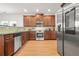 Charming kitchen with wooden cabinets, stainless steel appliances and granite countertops at 3897 Lake Sanctuary Way, Atlanta, GA 30349